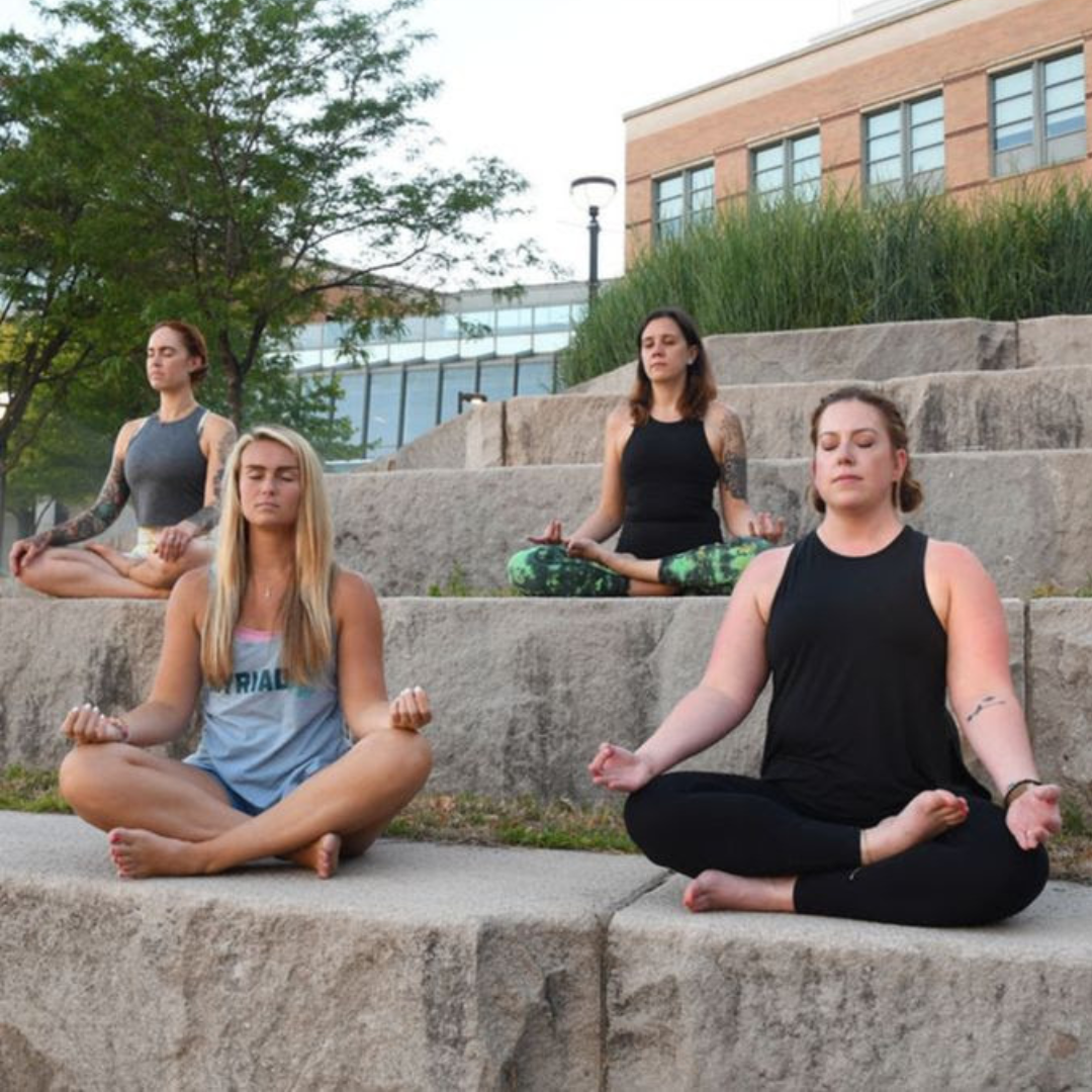 Marta Gruber, Jordan Nommay, Celia Sadjadi and Nicole Ast practice sukhasana