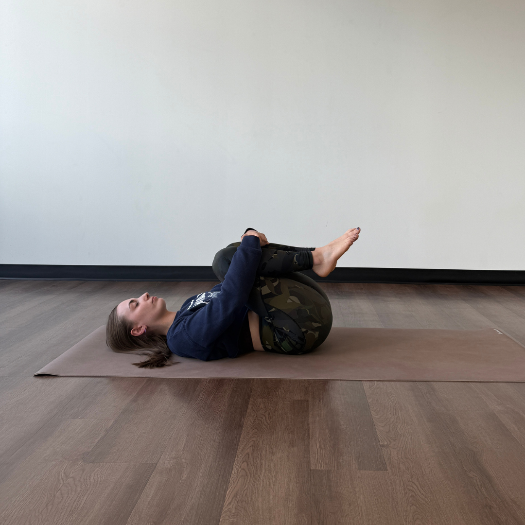 Zoe Lowden practices wind relieving pose