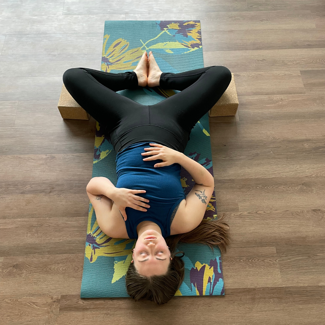 Zoe Lowden practices supta baddha konasana