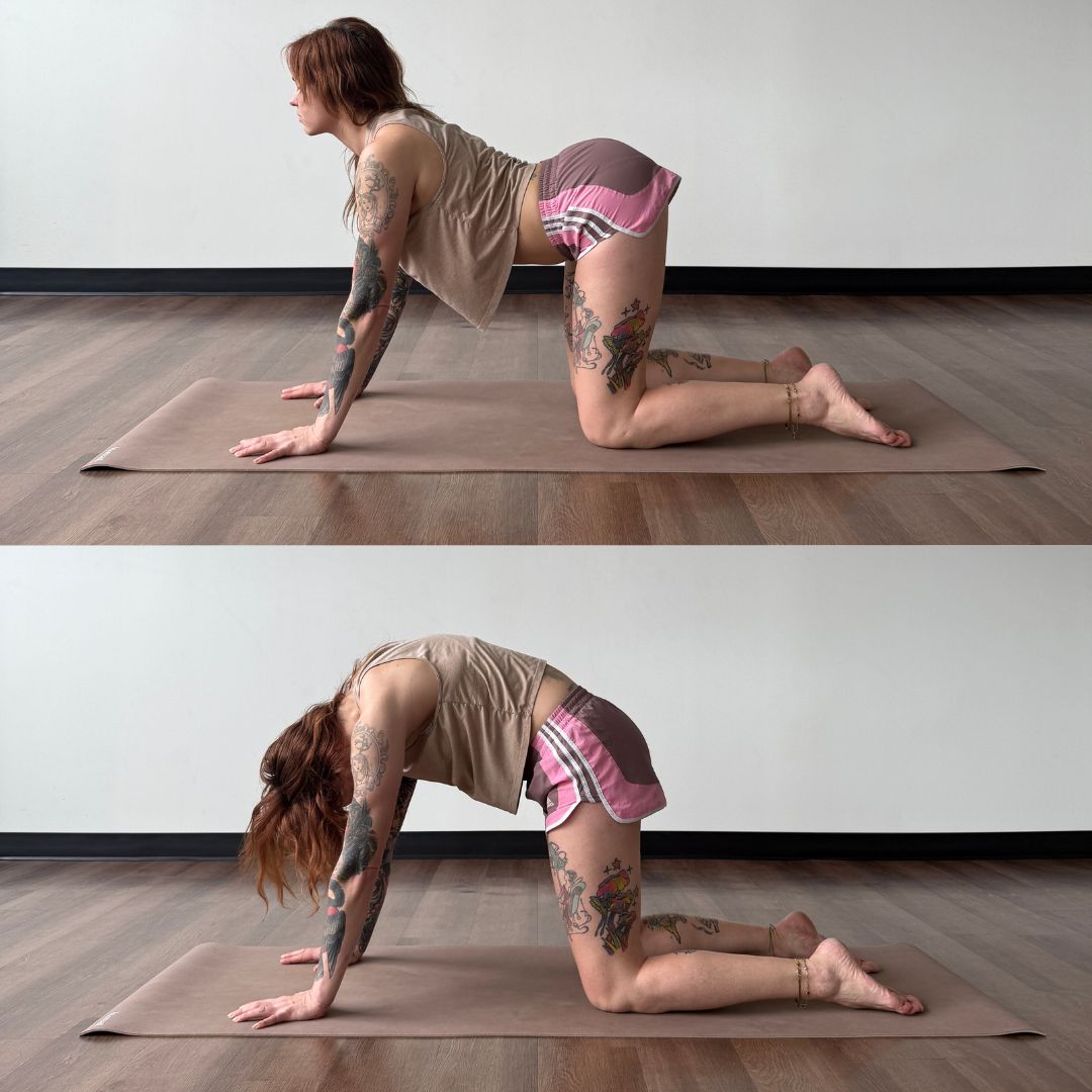 Marta Gruber, a white woman with red hair and tattoos practices bitilasana marjaryasana on a beige yoga mat. 